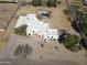 Expansive aerial view of a modern white home with a gated pool and desert landscaping at 22236 E Nacoma --, Queen Creek, AZ 85142