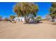 Rear exterior showcasing minimal landscaping and a partially fenced backyard at 22236 E Nacoma --, Queen Creek, AZ 85142