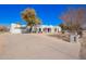 Front exterior view of a desert home with a circular driveway and desert landscaping at 22236 E Nacoma --, Queen Creek, AZ 85142
