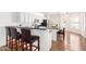 Eat-in kitchen boasts white cabinets, granite counters, stainless appliances, and breakfast bar at 22236 E Nacoma --, Queen Creek, AZ 85142