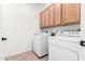 Functional laundry room with washer, dryer, and plenty of storage at 22236 E Nacoma --, Queen Creek, AZ 85142