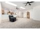 Bright living room featuring plush carpeting, ceiling fans, and skylights for ample natural light at 22236 E Nacoma --, Queen Creek, AZ 85142