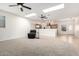 Bright living room featuring plush carpeting and a view of the open kitchen area at 22236 E Nacoma --, Queen Creek, AZ 85142