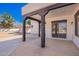 Covered patio with dark-stained supports and stamped concrete at 22236 E Nacoma --, Queen Creek, AZ 85142