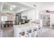 Bright, open kitchen featuring a quartz breakfast bar, stainless appliances, and adjacent dining area at 2360 E Ivy St, Mesa, AZ 85213