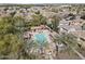 Aerial view of community pool area surrounded by palm trees and well-maintained landscaping at 2568 E Boston St, Gilbert, AZ 85295