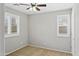 Bedroom featuring carpet floors, neutral paint, ceiling fan, and large windows at 2568 E Boston St, Gilbert, AZ 85295