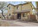 Two story tan home with stone veneer accents and a covered front entryway at 2568 E Boston St, Gilbert, AZ 85295