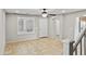Living room with tile floors, neutral paint, ceiling fan, and large windows at 2568 E Boston St, Gilbert, AZ 85295