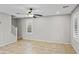 Living room with tile floors, neutral paint, ceiling fan, and large windows at 2568 E Boston St, Gilbert, AZ 85295