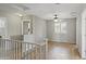 Open loft area with wood floors, ceiling fan, and natural light, perfect for a home office or second living space at 2568 E Boston St, Gilbert, AZ 85295