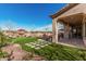 This backyard offers elegant landscaping, artificial turf and a covered patio at 28798 N 127Th Ave, Peoria, AZ 85383