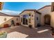 A private backyard patio with desert landscaping and brick pavers at 28798 N 127Th Ave, Peoria, AZ 85383