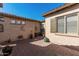 A private backyard patio with desert landscaping and brick pavers at 28798 N 127Th Ave, Peoria, AZ 85383