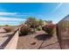 Well-kept backyard with desert landscaping, perimeter wall, and comfortable seating area at 28798 N 127Th Ave, Peoria, AZ 85383