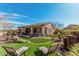 This home features a luxurious backyard with a covered patio and lush landscaping at 28798 N 127Th Ave, Peoria, AZ 85383