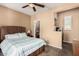 Bedroom featuring carpet flooring, ceiling fan, and connected bathroom and workspace at 28798 N 127Th Ave, Peoria, AZ 85383