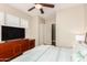 This bedroom features a ceiling fan, wood-look floor and built-in storage at 28798 N 127Th Ave, Peoria, AZ 85383