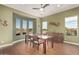 Bright dining room with large windows offering picturesque views, a modern table, and a stylish sideboard at 28798 N 127Th Ave, Peoria, AZ 85383