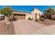 Single-story home with a desert landscape, brick driveway and a two car garage at 28798 N 127Th Ave, Peoria, AZ 85383