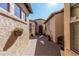 Backyard with a brick paver walkway, desert landscaping and a private patio at 28798 N 127Th Ave, Peoria, AZ 85383