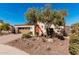 Charming single-story home with a well-manicured front yard, desert landscaping and a two car garage at 28798 N 127Th Ave, Peoria, AZ 85383