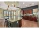Well-appointed kitchen with a large island, stainless steel appliances, and open layout connecting to the dining area at 28798 N 127Th Ave, Peoria, AZ 85383