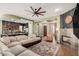 Open-concept living room with modern fireplace, and open access to the kitchen at 28798 N 127Th Ave, Peoria, AZ 85383