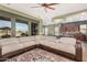 Open-concept living room boasts a large sectional sofa, views through expansive windows, and connection to the kitchen at 28798 N 127Th Ave, Peoria, AZ 85383