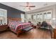 Serene main bedroom with large windows, plantation shutters, and a spacious layout including a desk and seating area at 28798 N 127Th Ave, Peoria, AZ 85383