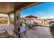This outdoor patio features elegant columns, stone pavers and elegant landscaping at 28798 N 127Th Ave, Peoria, AZ 85383