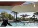 Outdoor pool area with palm trees, lounge chairs, and partial shade at 28798 N 127Th Ave, Peoria, AZ 85383