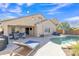 Private backyard showcasing a refreshing pool, lounge chairs, and covered patio seating area at 2910 E Quiet Hollow Ln, Phoenix, AZ 85024