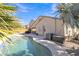Inviting backyard with a pool, patio, string lights, and well-maintained landscaping at 2910 E Quiet Hollow Ln, Phoenix, AZ 85024