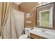 Bathroom featuring a tiled shower and a sink with a large, decorative mirror at 2910 E Quiet Hollow Ln, Phoenix, AZ 85024