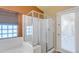 Bathroom featuring a tiled shower, glass block window, and access to the backyard at 2910 E Quiet Hollow Ln, Phoenix, AZ 85024