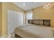 A well-lit bedroom featuring a bed with a headboard and a closet with sliding doors at 2910 E Quiet Hollow Ln, Phoenix, AZ 85024