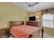 Comfortable bedroom featuring a patterned bedspread, wood furniture and a ceiling fan at 2910 E Quiet Hollow Ln, Phoenix, AZ 85024