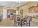 Spacious kitchen with wood cabinetry, granite countertops, and tile flooring open to breakfast area at 2910 E Quiet Hollow Ln, Phoenix, AZ 85024