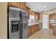 Modern kitchen featuring stainless steel appliances, wood cabinets and adjacent dining area at 2910 E Quiet Hollow Ln, Phoenix, AZ 85024