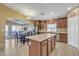 Open-concept kitchen featuring island, stainless appliances, and seamless flow to living area at 2910 E Quiet Hollow Ln, Phoenix, AZ 85024