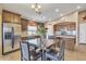 Inviting eat-in kitchen with granite counters, dark wood cabinets, and stainless steel appliances at 2910 E Quiet Hollow Ln, Phoenix, AZ 85024