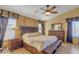 Comfortable main bedroom featuring a ceiling fan, neutral decor, and coordinated furniture set at 2910 E Quiet Hollow Ln, Phoenix, AZ 85024