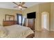 Relaxing main bedroom offering ceiling fan and coordinated wooden furniture, and natural light at 2910 E Quiet Hollow Ln, Phoenix, AZ 85024