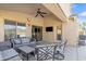 Comfortable covered patio with outdoor seating, ceiling fan, and mounted television at 2910 E Quiet Hollow Ln, Phoenix, AZ 85024