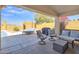 Covered patio with outdoor seating, grill, and sun loungers with a view of the pool at 2910 E Quiet Hollow Ln, Phoenix, AZ 85024