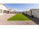 Spacious backyard features artificial turf, gravel landscaping, and a block wall for enhanced privacy at 38145 W Amalfi Ave, Maricopa, AZ 85138