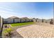 Beautifully landscaped backyard showcasing artificial turf, gravel areas, and a paved patio for outdoor enjoyment at 38145 W Amalfi Ave, Maricopa, AZ 85138