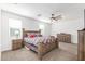 Cozy bedroom featuring rustic wood furniture, a ceiling fan, and carpeted floors at 38145 W Amalfi Ave, Maricopa, AZ 85138