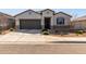 Charming single-story home with a two-car garage and a well-maintained desert landscape at 38145 W Amalfi Ave, Maricopa, AZ 85138
